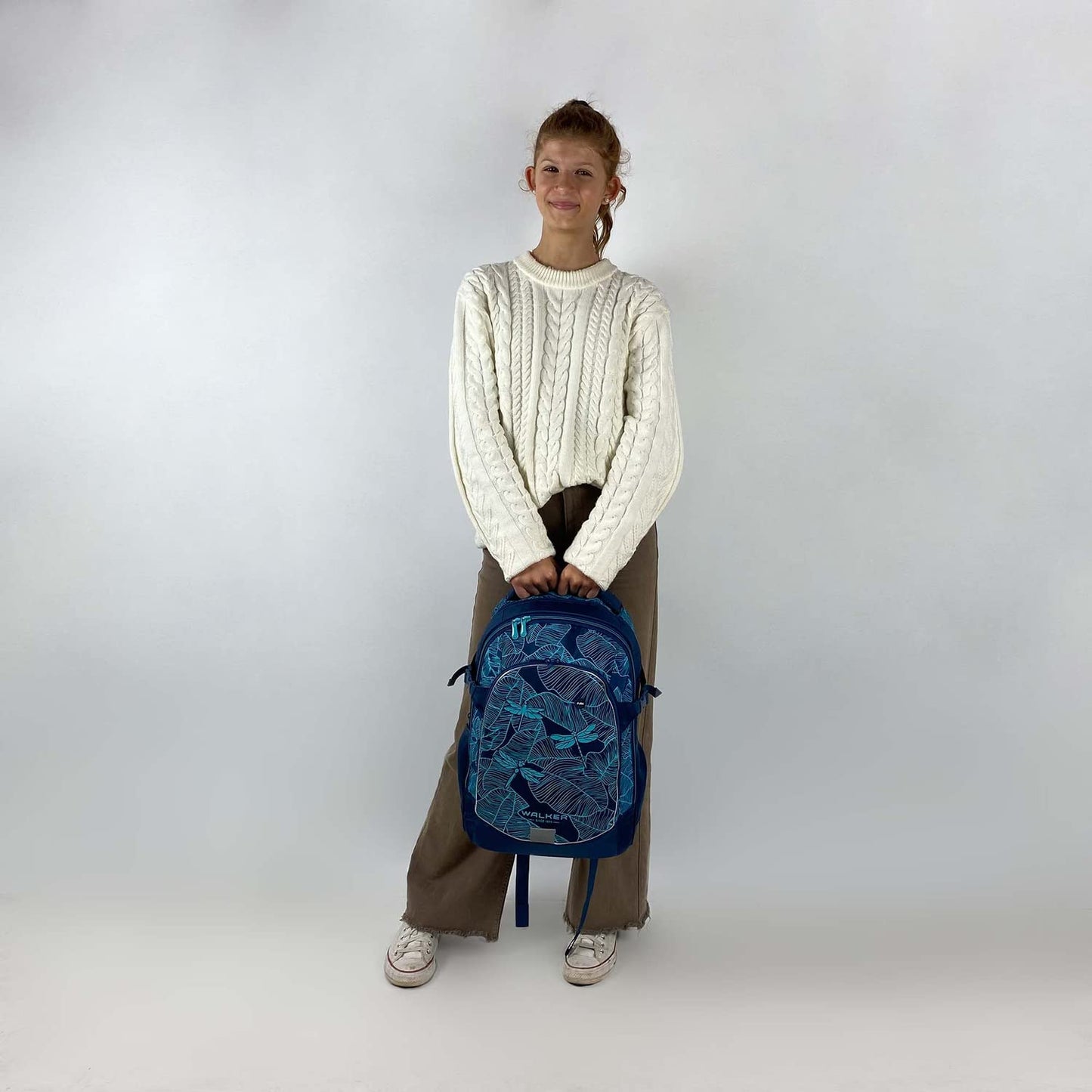 Walker school backpack Fame 2.0 "Glow in the Dark" with 2 compartments, side pockets, and glowing effect. School bag includes back padding, adjustable shoulder, and chest straps.