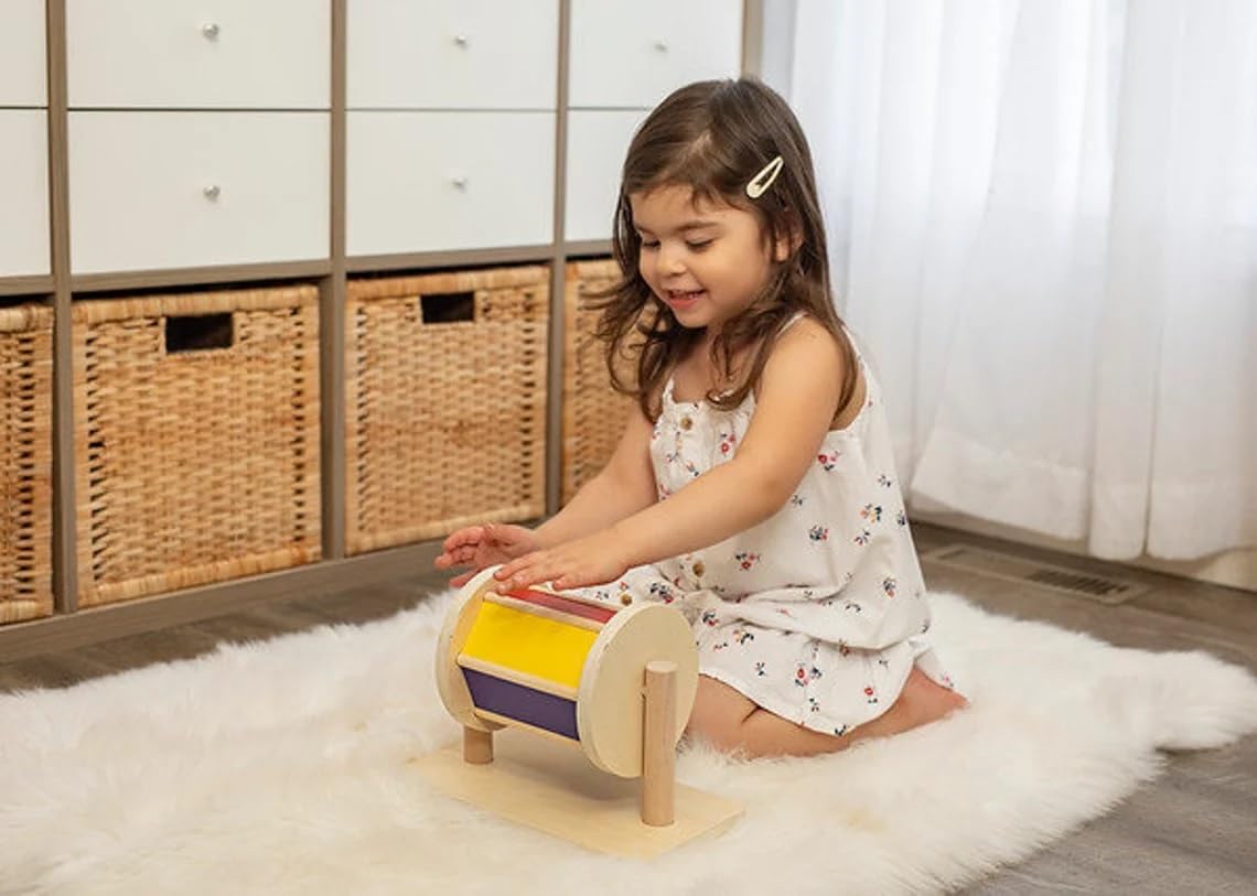 YAANI Montessori Spinning Drum is a Montessori toy for infants aged 6-12 months and 1 year old toddlers. It's the best baby gift idea.