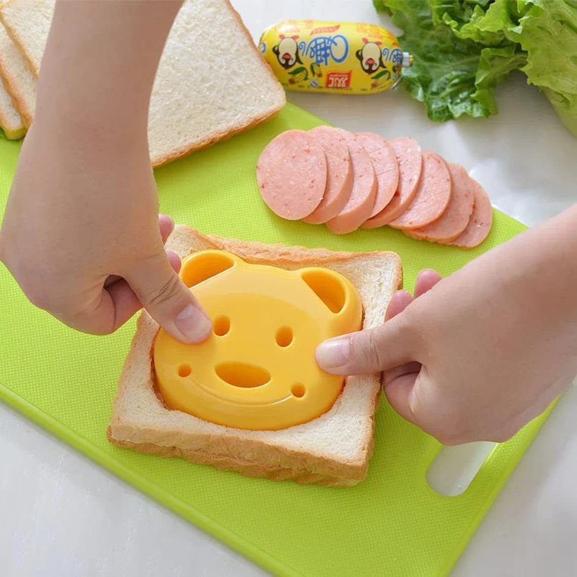 47-piece children's kitchen knife set with dinosaur cookie cutters and kid-friendly knives for cutting cakes, cookies, fruit, sandwiches, and vegetables.