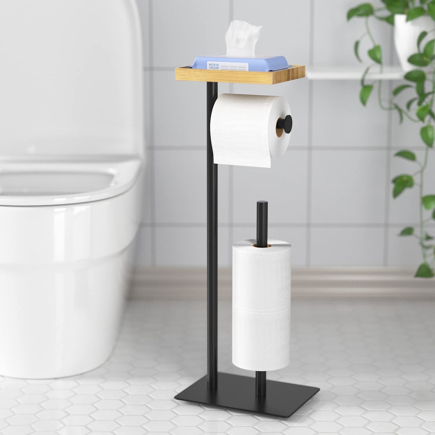 Free-standing toilet paper holder with top shelf in bamboo, black toilet paper roll holder stand, floor-standing toilet paper dispenser with space for 4 spare rolls.
