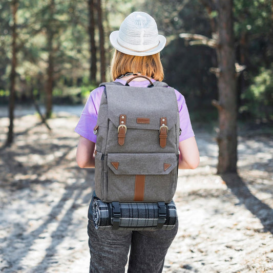 HappyPicnic insulated picnic backpack for 4 people with complete tableware set, spacious cooler compartment, bottle holders, and large waterproof picnic blanket.