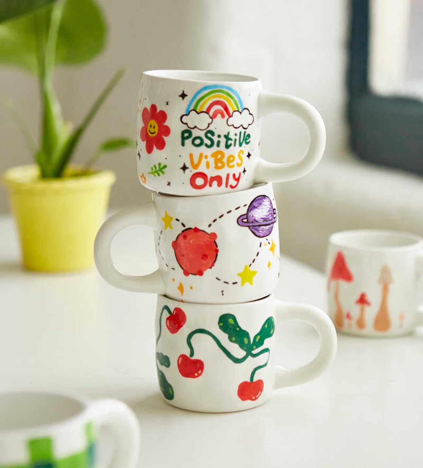 Pott'd Paintables cups for adults, ceramic painting set with cups, paints, brushes, and painting inspirations for painting the cups yourself.