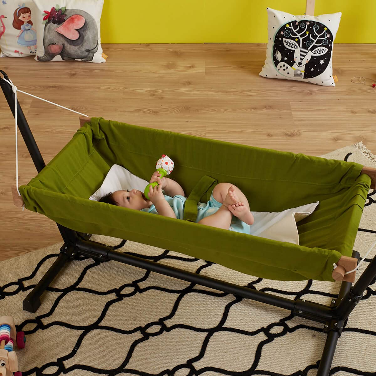 Baby Hammock with Stand. Made from 100% cotton, this travel-friendly baby hammock comes with a wooden swing stand for your little one to rest and play comfortably.