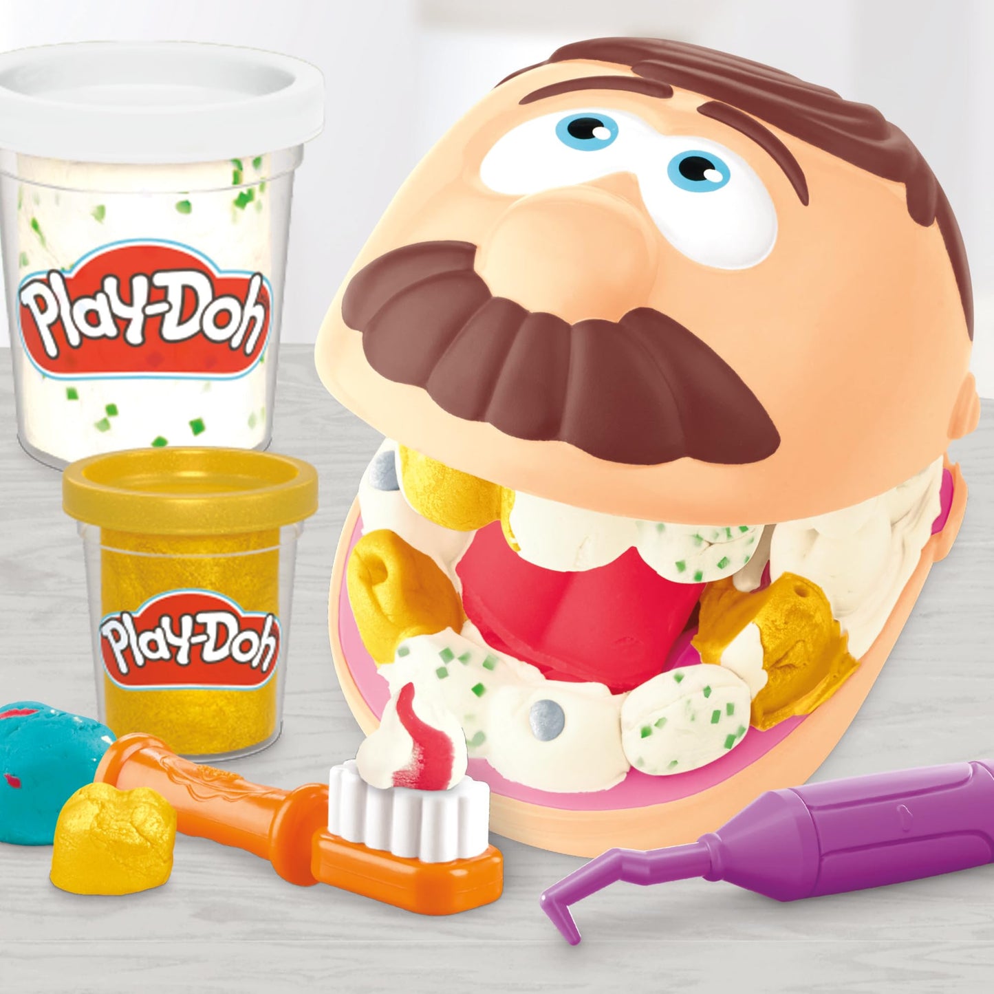 Play-Doh Dentist Dr. Wackelzahn Craft Set with 8 x 56g Tubs and 10 tools for shaping, with cavity clay and metallic clay, creative fun for kids.