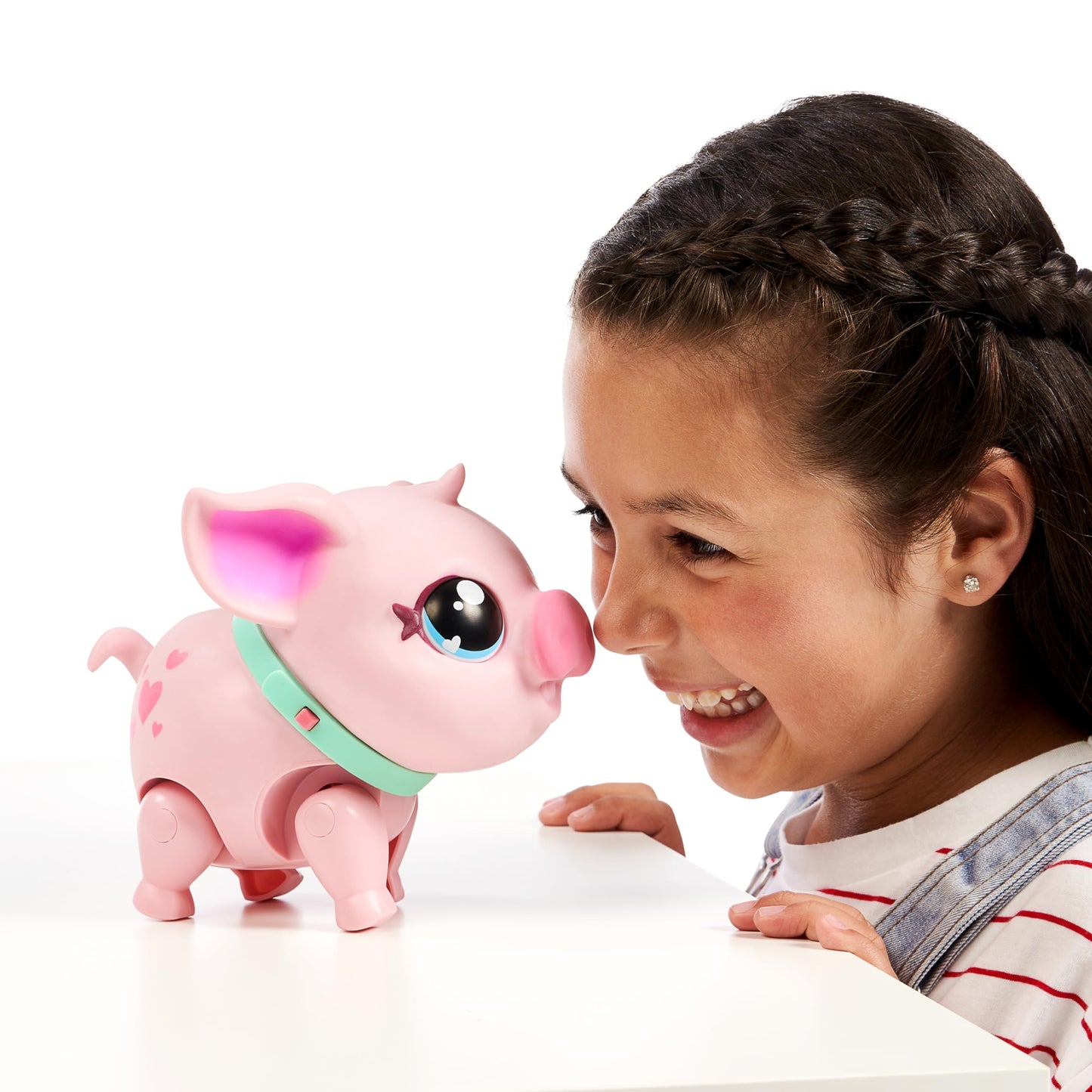 Little Live Pets - My Pet Pig, a cuddly interactive toy pig that walks, dances, and nuzzles. Featuring 20+ sounds and reactions. Batteries included. Ideal for kids ages 4 and up. Pink color.