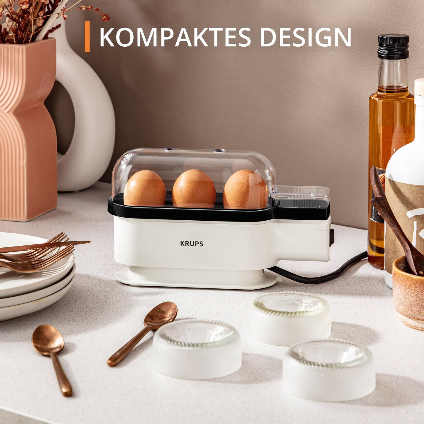 Krups Ovomat Trio egg cooker, For up to 3 eggs, Includes water measuring cup with egg piercer, egg holder, signal tone, EG234115, White/Black