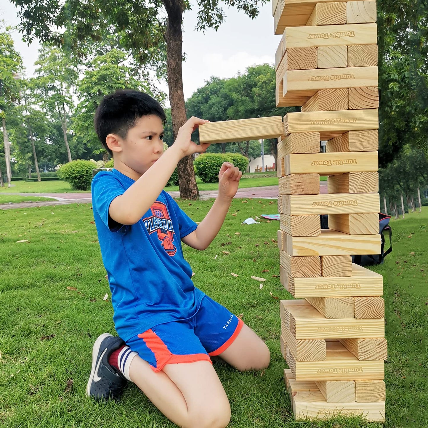 Jac & Mok Giant Tumble Tower game made of pine wood. Includes 60 building blocks and a carrying bag for outdoor fun.