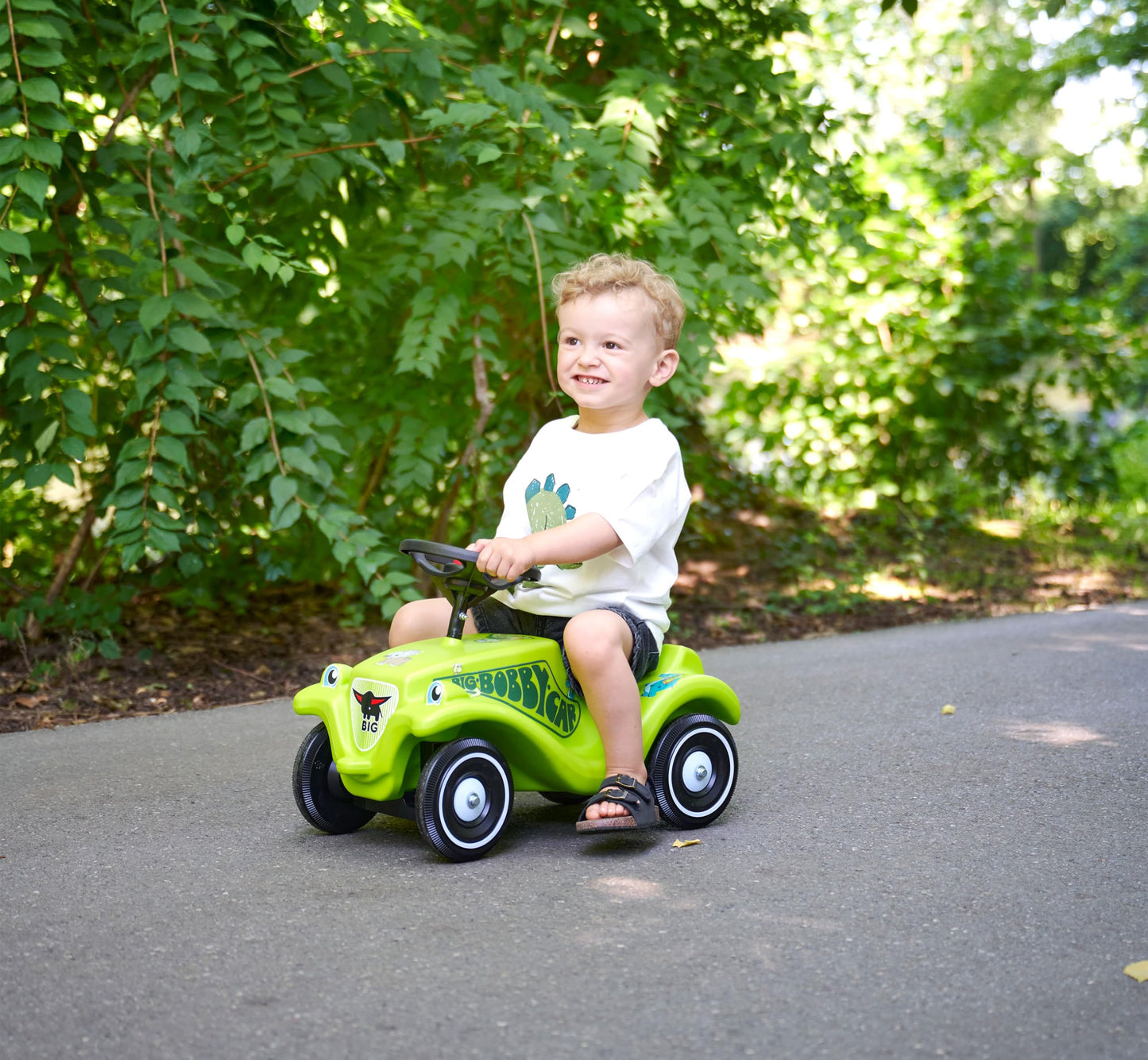 Big Bobby Car Classic Dino - Slide car for ages 1 and up in colorful dino design with black safety steering wheel and horn, for children from 12 months (up to 50 kg), green with stickers