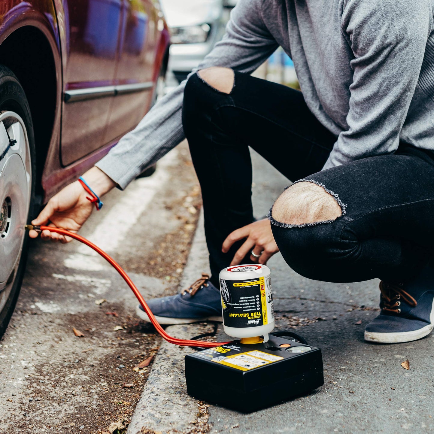 AirMan Resq tire repair kit for cars, featuring Valve-Through technology, repairs all tire types, including the powerful 12V air compressor tire sealant.