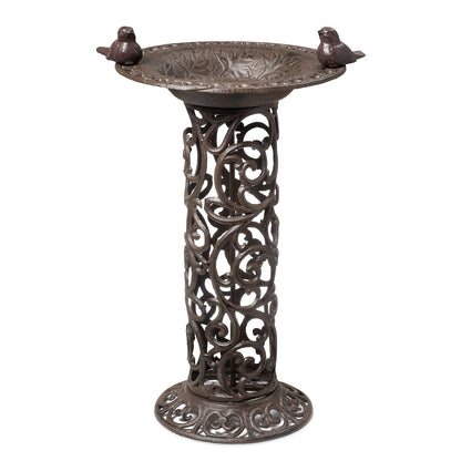 Large bird bath with decorative birds made of cast iron. Metal water bowl for feeding and garden decoration.