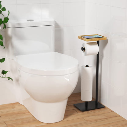 Free-standing toilet paper holder with top shelf in bamboo, black toilet paper roll holder stand, floor-standing toilet paper dispenser with space for 4 spare rolls.