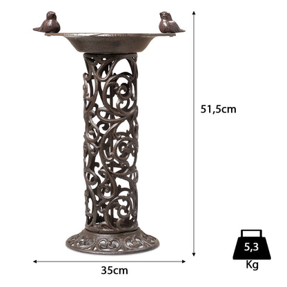 Large bird bath with decorative birds made of cast iron. Metal water bowl for feeding and garden decoration.
