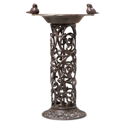 Large bird bath with decorative birds made of cast iron. Metal water bowl for feeding and garden decoration.