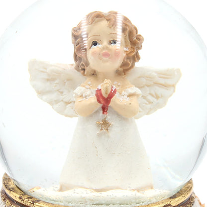 Snow globe/shake ball standing angel with star in hand, antique base with roses, size L/W/H approx. 8 x 6.5 x 8 cm, Ø ball 6 cm.