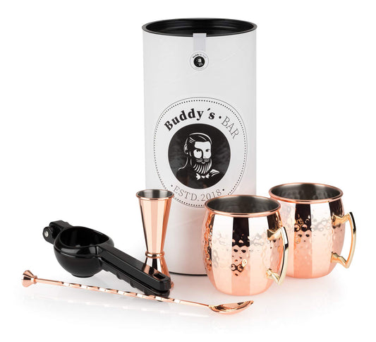 Buddy's Bar - Moscow Mule Complete Set features 2 x 500 ml cocktail cups, 27 cm bar spoon, 5 cl jigger & black lime squeezer, food-safe and comes in a gift box. Copper hammered design.