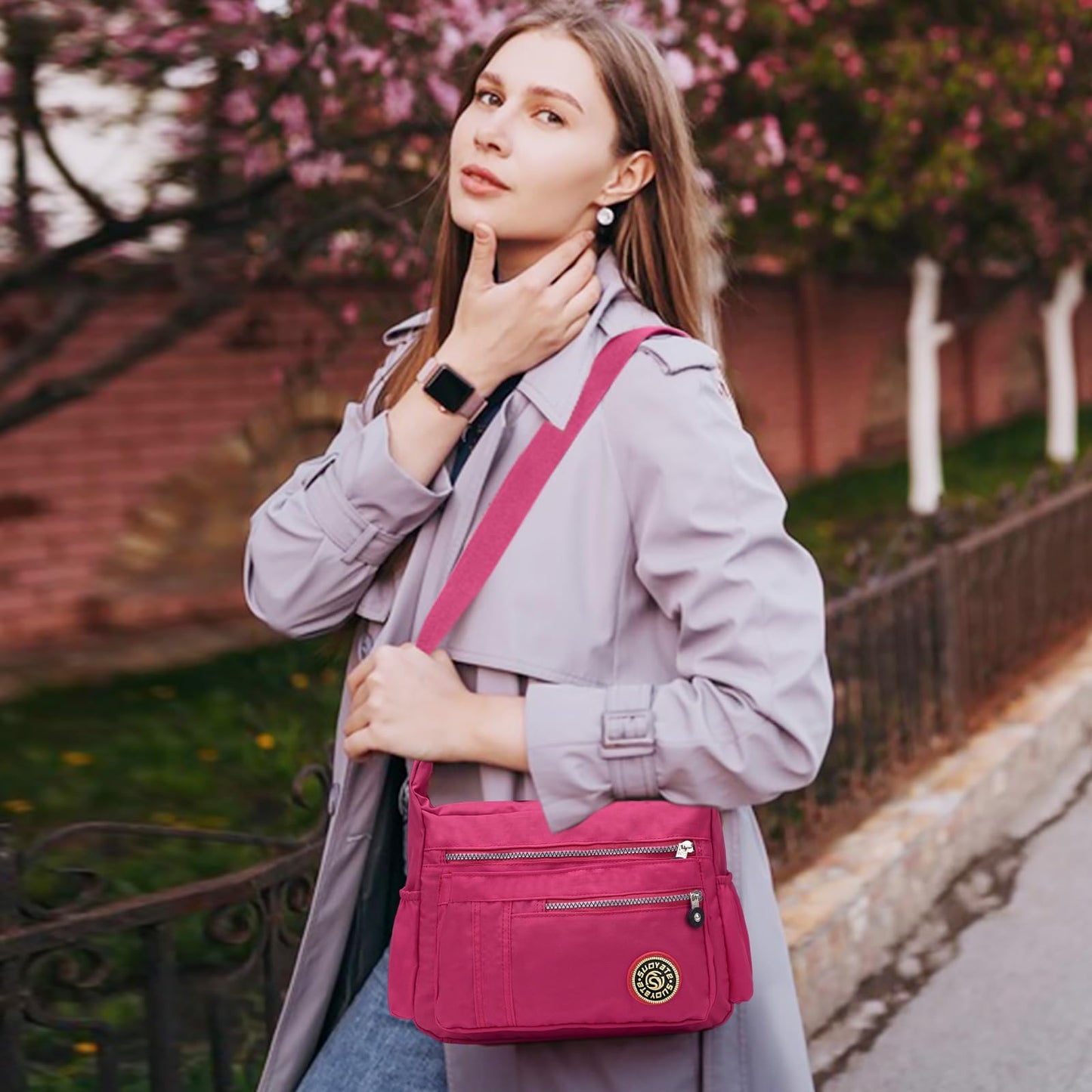 NICOLE & DORIS women's crossbody messenger bag in casual pink nylon, featuring multiple pockets and a zipper closure.