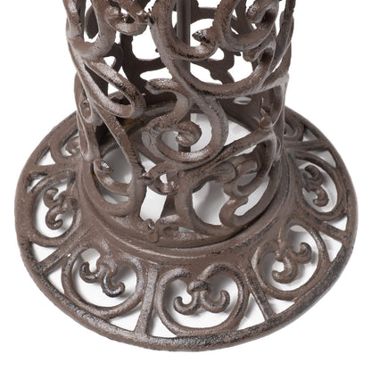 Large bird bath with decorative birds made of cast iron. Metal water bowl for feeding and garden decoration.