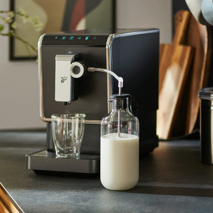 Tchibo coffee machine Esperto Pro with matching glass milk carafe, perfect for Caffè Crema, Espresso, and milk specialties, 600ml milk container, anthracite color.