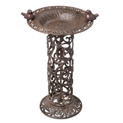 Large bird bath with decorative birds made of cast iron. Metal water bowl for feeding and garden decoration.