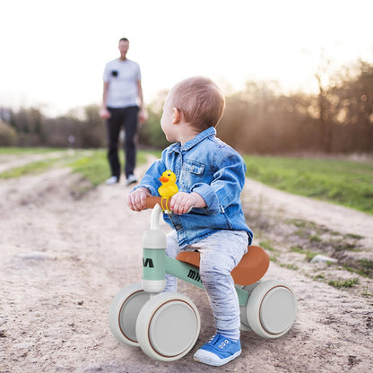 Toddler balance bike for 1 year and up, with 4 wheels for 10-24 month old babies. First ride-on bike for boys and girls as a gift - light green.