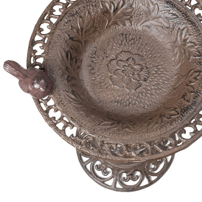 Large bird bath with decorative birds made of cast iron. Metal water bowl for feeding and garden decoration.